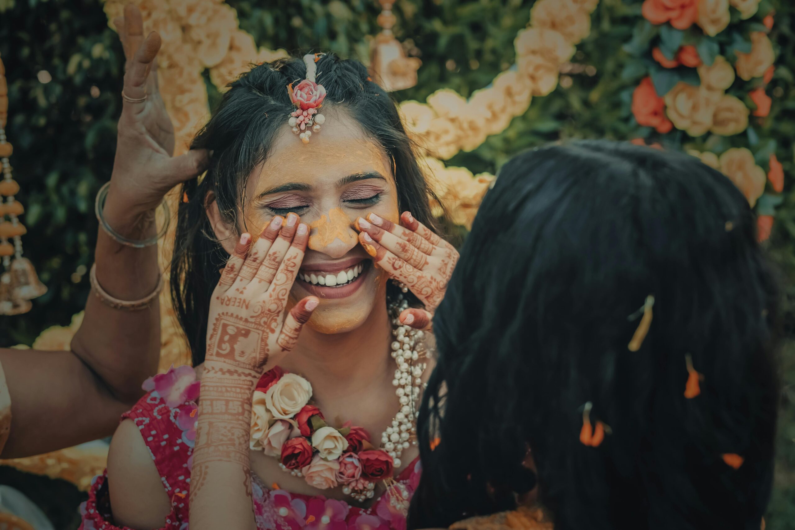Indian bride enjoying the Haldi ritual with family and friends