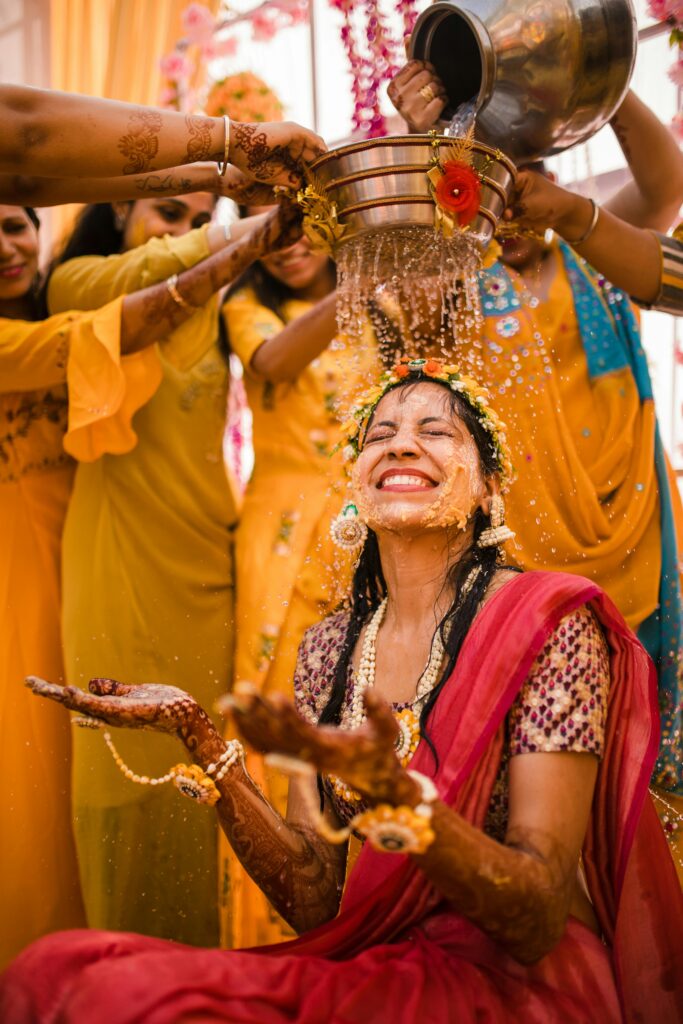 Indian Haldi ceremony with bride smiling during wedding rituals