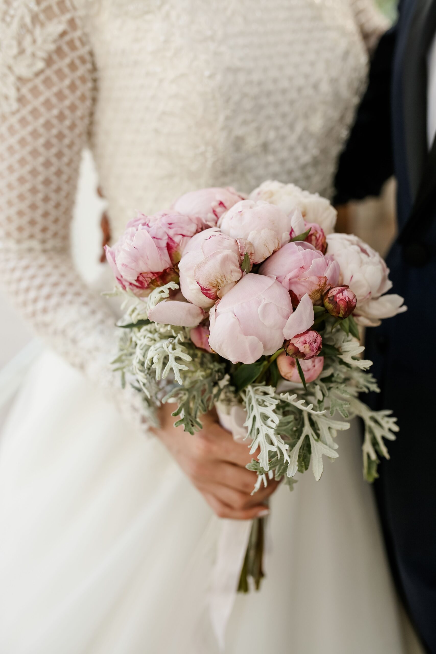 Bride holding a beautiful pink flower bouquet on her wedding day